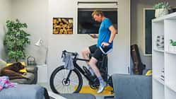 Man using his cycling turbo trainer in the living room