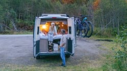 A Couple Experiencing Cozy Van Life Adventure in Autumn Forest