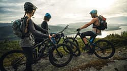Group of friends mountainbike riders: MTB biking outdoor up mountain of Norway