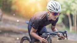 Young man Cyclist riding mountain bike on trail at moring