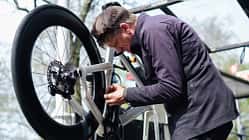 Bicycle mechanic repairing a bike in his workshop