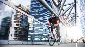 Commuter cycling fast at work in the morning