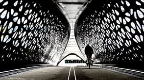 Cyclist crossing a tunnel bridge