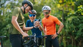 Asian Chinese male Professional cyclist resting in rural scene, showing smartphone mobile app GPS coordinates to his team . Travel, sport and modern technology concept. Asian Chinese male Professional cyclist resting in rural scene, showing smartphone mobile app GPS coordinates to his team . Travel, sport and modern technology concept.