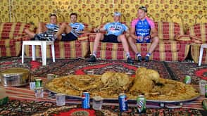 Unidentified cyclists rest in a tent in front of a Unidentified cyclists rest in a tent in front of a
