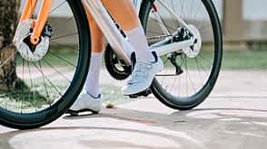 low section portrait asian chinese female cyclist riding her bicycle in public park low section portrait asian chinese female cyclist riding her bicycle in public park