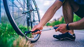 Man pumping bicycle wheel