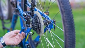 Service technician adjusting bike gears