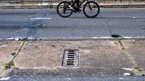 down,elevated,physical,wall bicycle and manhole on street in Sao Paulo