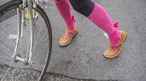 girl in fuchsia stockings pushes an old bicycle. girl in fuchsia stockings pushes an old bicycle.