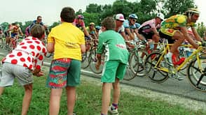 Three children wearing the polka-dot jersey of the Three children wearing the polka-dot jersey of the