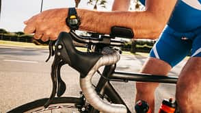 people,caucasian appearance,Adults,man,mature men,mature adult,50 Plus Years,50-54 years,sky,clear sky,Plant,Tree,Palm,side view,Spain,Balearic Islands,Majorca,Sa Coma,driving,sport,athlete,cyclist,racing biker,on the move,riding bicycle,Part Of,midsection,leaning,vehicle,bike,bicycle,racing cycle,hobby,leisure,Recreational Pursuit,leisure time sports,Sports Wear,human hand,arm,watch,wrist watch,healthy lifestyle,training,fitness,day,outdoor,handlebar,road,endurance sports,triathlete,close up,only men,One Person,one man only,determination,Triathlon Spain, Mallorca, Sa Coma, triathlet training on bicycle, close-up