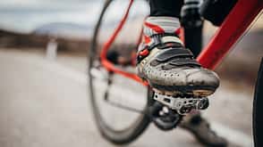 Male cyclist foot on bicycle pedal Male cyclist foot on bicycle pedal
