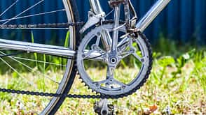 Chainring, chain, front derailleur, crank, pedals on vintage racing bicycle Chainring, chain, front derailleur, crank, pedals on vintage racing bicycle