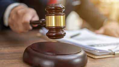 Close up lawyer businessman working or reading lawbook in office workplace for consultant lawyer concept.