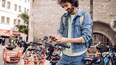 Young tourist renting an e-bike to explore Barcelona