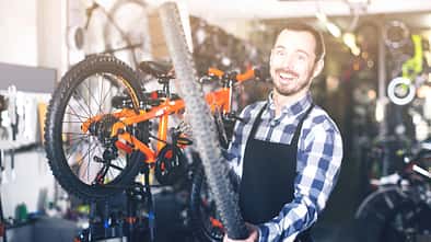 Man  change a wheel on a bicycle