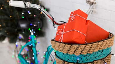 Magic Christmas bicycle with gifts and pine tree on background