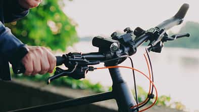 Young man with bike using smartphone