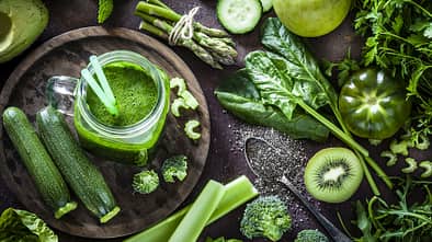 Detox diet concept: green vegetables on rustic table