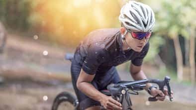 Young man Cyclist riding mountain bike on trail at moring