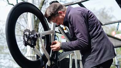 Bicycle mechanic repairing a bike in his workshop