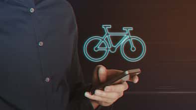 Young Business Man Using Smartphone with Bicycle Icon