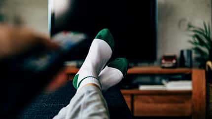 Personal perspective of a woman watching television in a living room Personal perspective of a woman watching television in a living room