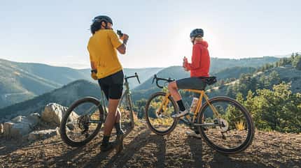 Cinder Cargo Bib Shorts QFV-47-BLK, Cinder Jersey QBL-51-SAH, Women's Cargo Bib Shorts QFV-48-ORB, Women's Cinder Jersey QBL-52-RGP, Adult, Bicycle, Footwear, Helmet, Male, Man, Person, Photography, Shoe, Vehicle