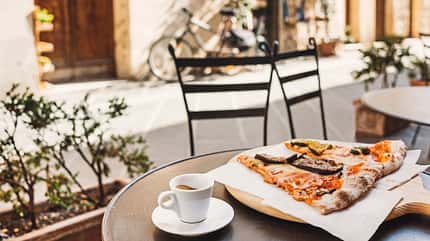 Vacations in Italy. Pizza and coffee in italian cafe Vacations in Italy. Pizza and coffee in italian cafe
