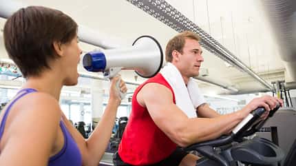 body,attractive,attractive male,20s,female,caucasian,male Personal trainer shouting at client through megaphone