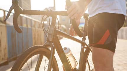 activity Cyclist with his bike in the city