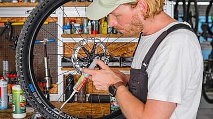 Mountainbike Tubeless umruesten Dichtmilch in den Mantel spitzen