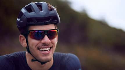 Young cyclist smiling with helmet and sunglasses Young cyclist smiling with helmet and sunglasses