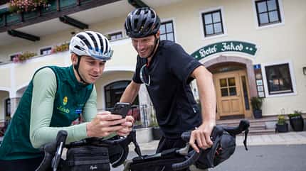 SalzburgerLand,Gravel,Bike,Biker auf das Handy schauend SalzburgerLand,Gravel,Bike,Biker auf das Handy schauend