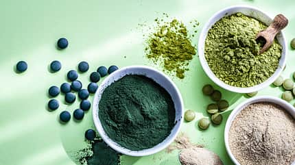 Spirulina, Maca and Moringa powders on green background Spirulina, Maca and Moringa powders on green background