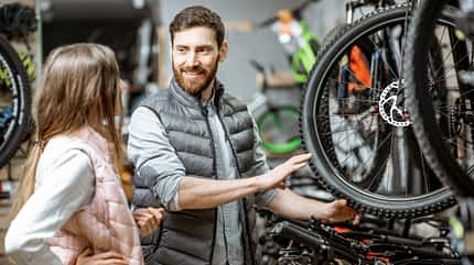 choise Woman with salesman in the bicycle store