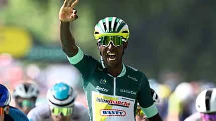 Radsport, Sieg, Emotion, Rennen, uvex, Helm
Ein jubelnder Rennradprofi hebt die Hand nach einem erfolgreichen Rennen, umgeben von anderen Fahrern.