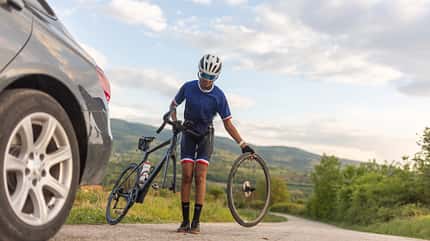 Young female athlete preparing to ride a bike through countryside