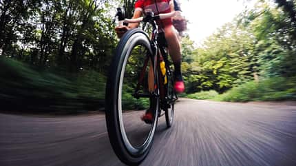Pursuit,Sports Helmet,Men,Cycle,Sports Training,Hobbies,Adult,Exercising,Fun,Ethnicity,One Person,Wheel,Strength,Action,Competition,Endurance,Effort,Determination,Creativity,Speed,Motion,Sport,Outdoors,Blurred Motion,Horizontal,Professional Sport,Athlete,Triathlon,Motorsport,Cycling,People,Day,Woodland,Road,Park - Man Made Space,Clothing,Bicycle,Cyclist,Triathlete Motion blurred cyclist