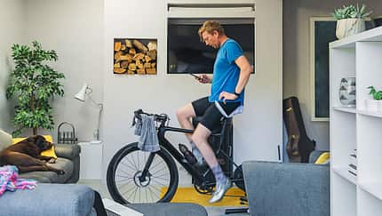 Man using his cycling turbo trainer in the living room