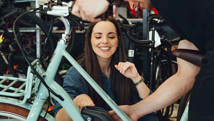 Man showing customer new e-bike in bike shop