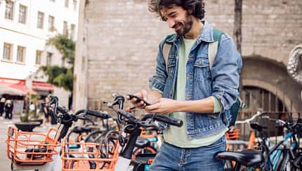 Young tourist renting an e-bike to explore Barcelona