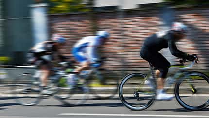 cyclists run on the city street