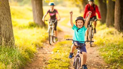 Happy family cycling in the countryside