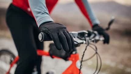 Male cyclist riding bicycle on road
