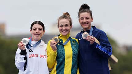 Gold medalist Grace Brown of Team Australia (C), Silver medalist Anna Henderson of Team Great Britain (L) and Bronze medalist Chloe Dygert of Team United States (R) pose on the podium during the Women's Individual Time Trial on day one of the Olympic Games Paris 2024 at Pont Alexandre III on July 27, 2024 in Paris, France. (Photo by Tim de Waele/Getty Images)