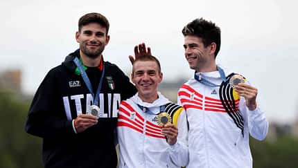 Gold medalist Remco Evenepoel of Team Belgium (C), Silver medalist Filippo Ganna of Team Italy (L) and Bronze medalist Wout van Aert of Team Belgium (R) pose on the podium at the Pont Alexandre III, during the Men's Individual Time Trial on day one of the Olympic Games Paris 2024 at Pont Alexandre III on July 27, 2024 in Paris, France. (Photo by Tim de Waele/Getty Images)