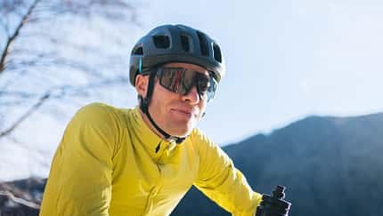 Road bicyclist relaxes in sunny city park
