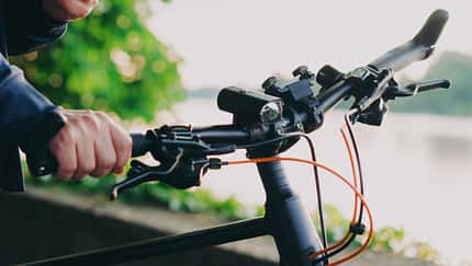 Young man with bike using smartphone